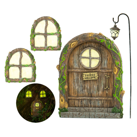 Tree Poetry enchanted fairy door mounted on a tree in a lush outdoor garden surrounded by ferns and ground cover