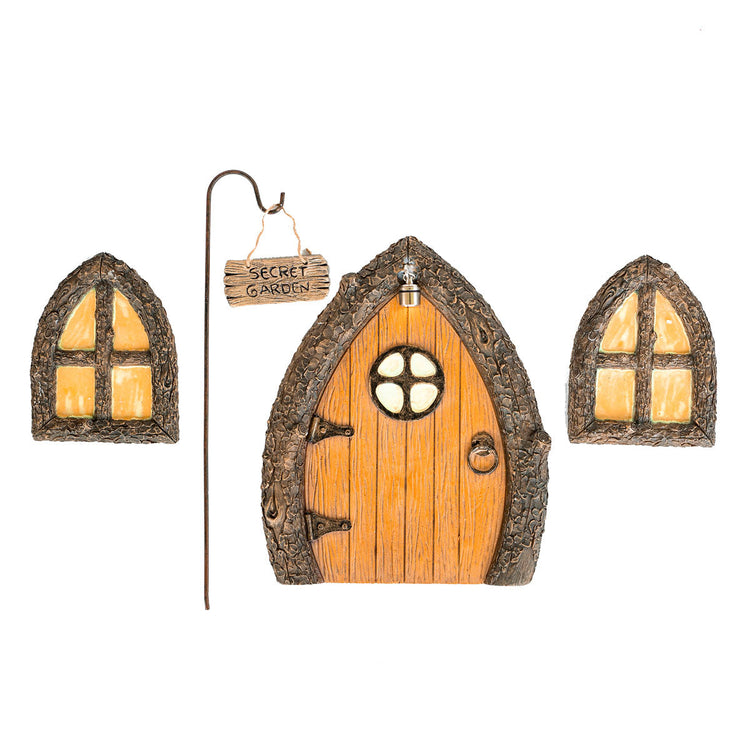 Hand-painted fairy door, window and Secret Garden sign set nestled at the base of a mossy garden tree