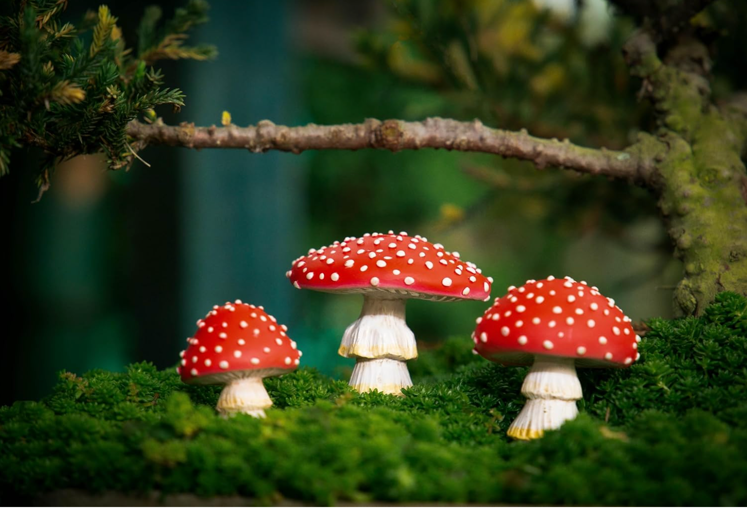 Tree Poetry mushroom figurine lifestyle photo nestled among garden plants and foliage showing scale and placement