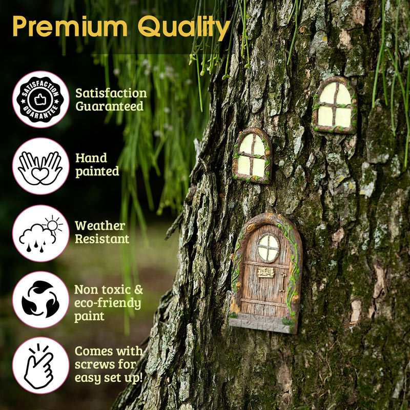 Enchanted fairy door and two glow in the dark windows photographed at night on a tree showing soft luminescent glow