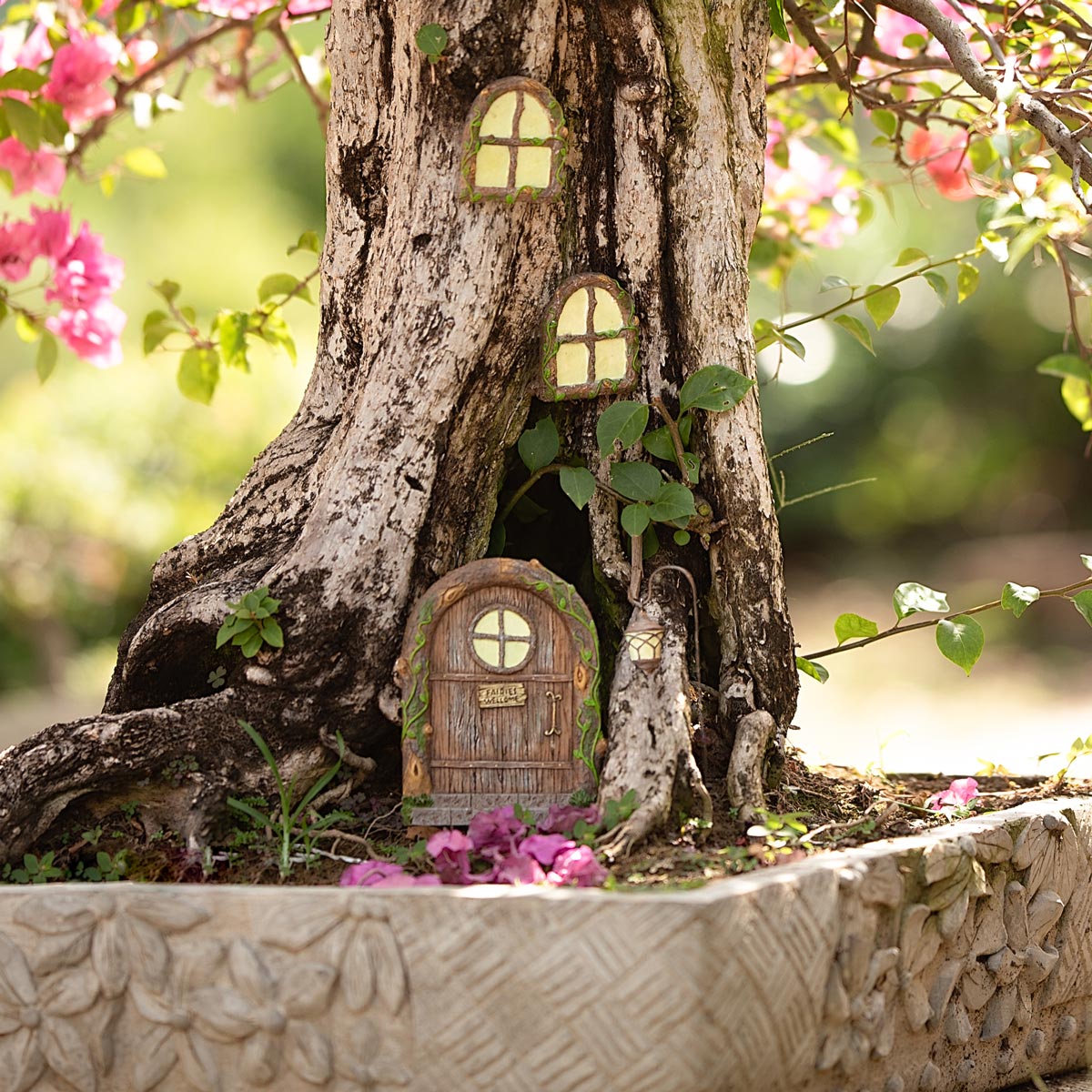 Enchanted fairy door kit installed on a garden fence post with surrounding flowers showing versatile placement options