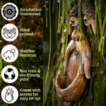 Close-up detail of hand-painted tree face bird feeder showing textured bark finish, sculpted eyebrows and expressive eyes