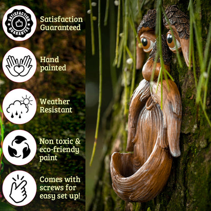 Close-up detail of hand-painted tree face bird feeder showing textured bark finish, sculpted eyebrows and expressive eyes