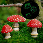 Group of hand-painted polyresin mushroom garden figurines arranged at the base of a tree in an outdoor garden