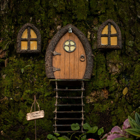 Full product flat-lay of fairy door and window set with Secret Garden sign on a neutral studio background